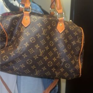 (Non-authentic) LV purse, medium size with red interior.